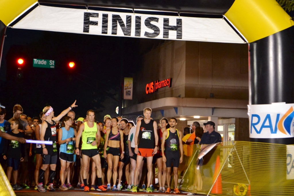 Runners line up at the Moonlight Madness 5k starting line, located at the intersection of Trade and West 4th Street.