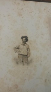 Frontispiece portrait of Walt Whitman, Leaves of Grass, 1855. Bearded man, head titled, with hat and casual attire